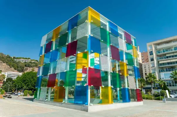 The colourful glass cube building underneath which is the Centre Pompidou in Malaga
