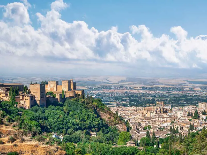 A view of the Alhambra on the left, with the city of Granada at its foothills, on the right.